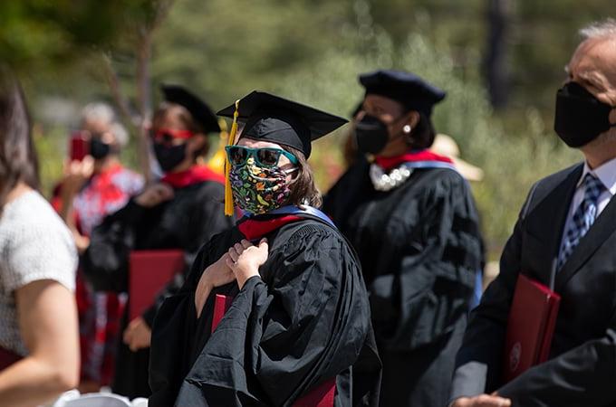 Students from the Graduate School of Theology wear masks and participate in a Commencement ceremony.