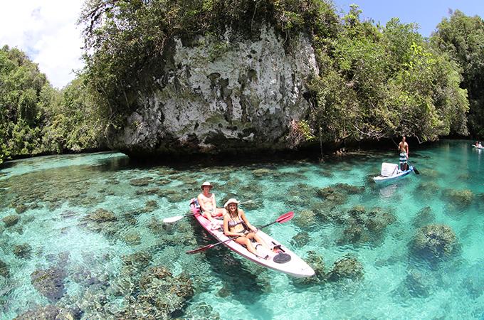 Students kayak in the clear waters of Palau