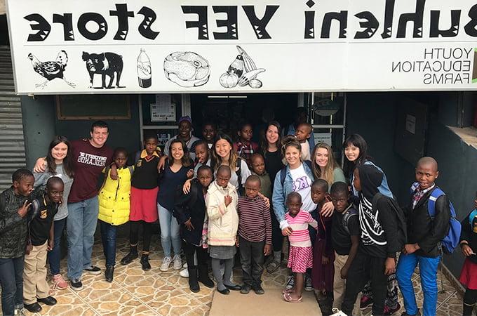 Redlands team with Swazi children near a Hospital they rebuilt